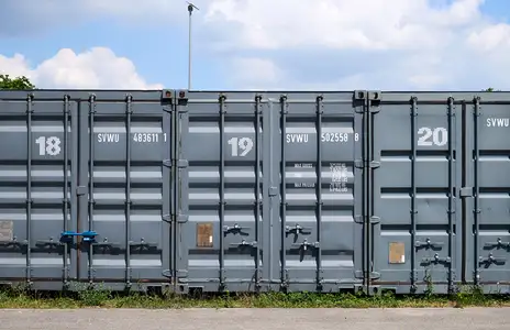 Drei graue Container von Sirius in Heidenheim, nummeriert 18, 19 und 20, stehen nebeneinander auf einem Außenbereich.