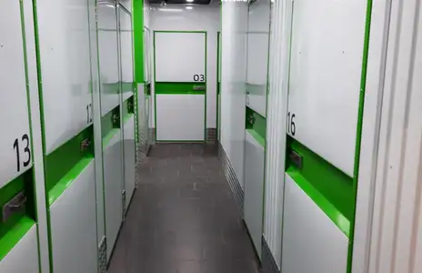 Lagerraum-Innenansicht von Storebox mit nummerierten Türen und grünen Akzenten in Landsberg am Lech.